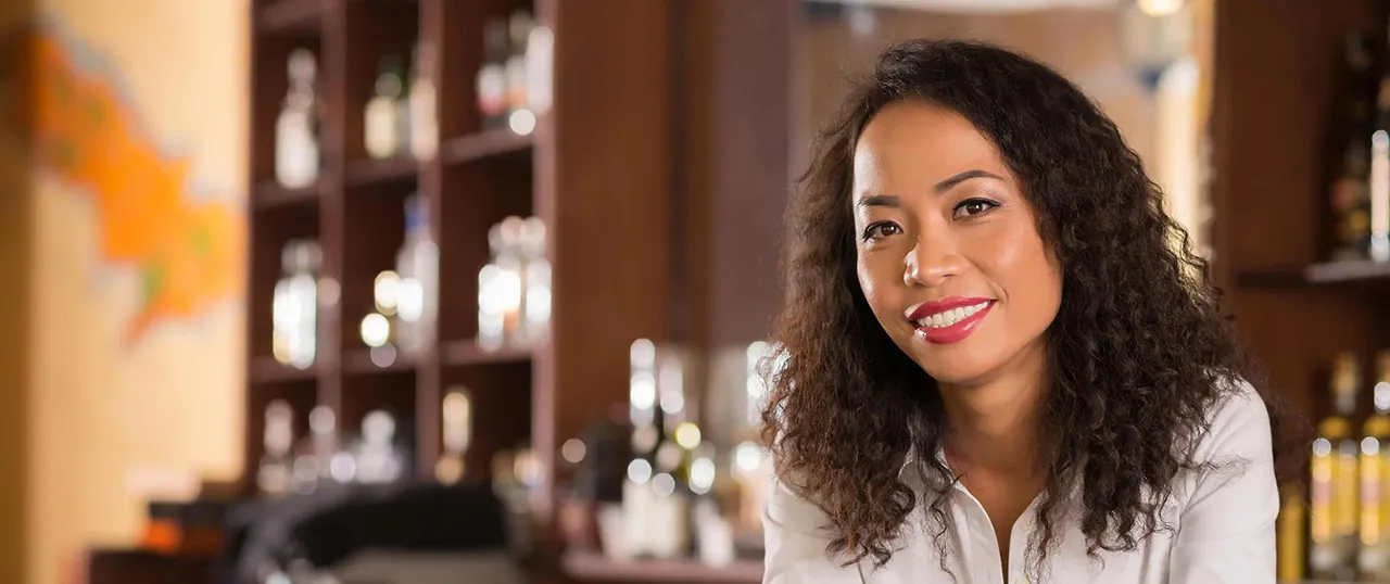 Female African American bartender behind bar