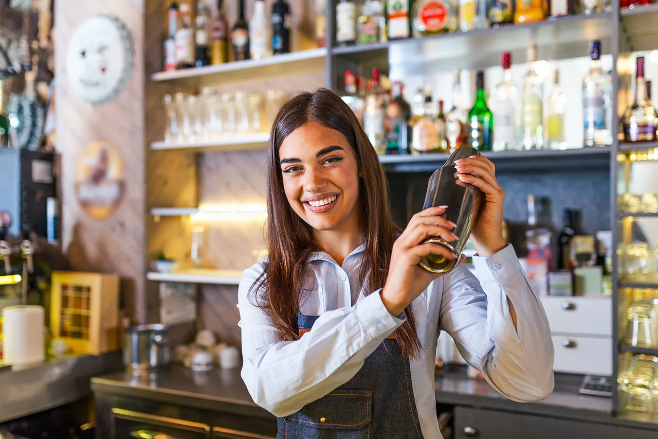 Female bartender with drink shaker