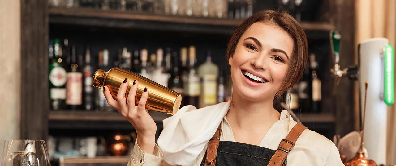 Female bartender with drink shaker