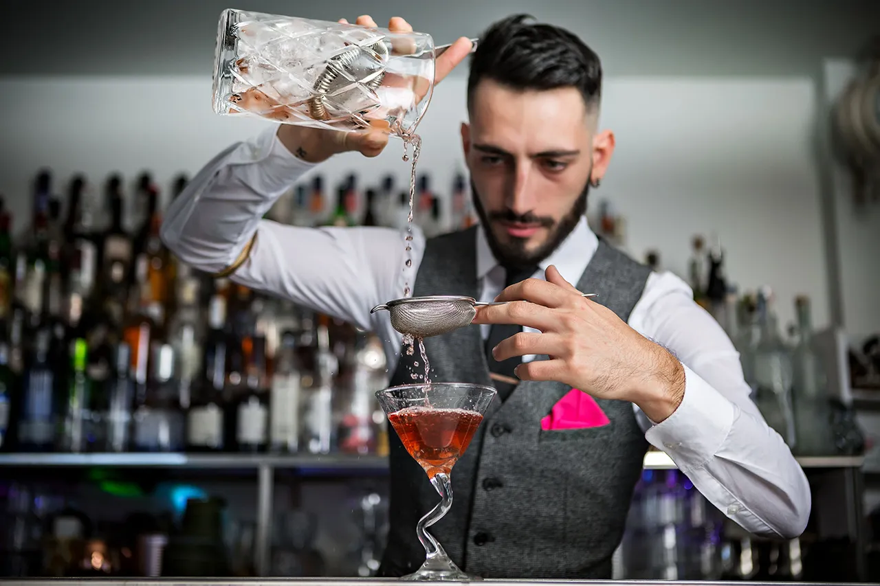 Male bartender mixing a drink