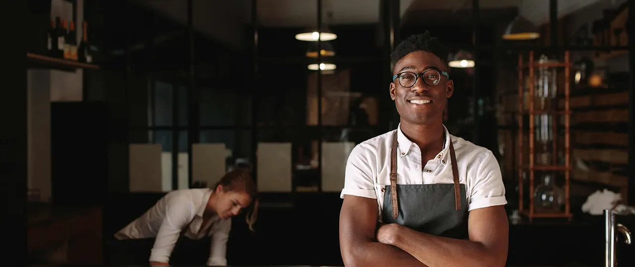 Male African American server in restaurant