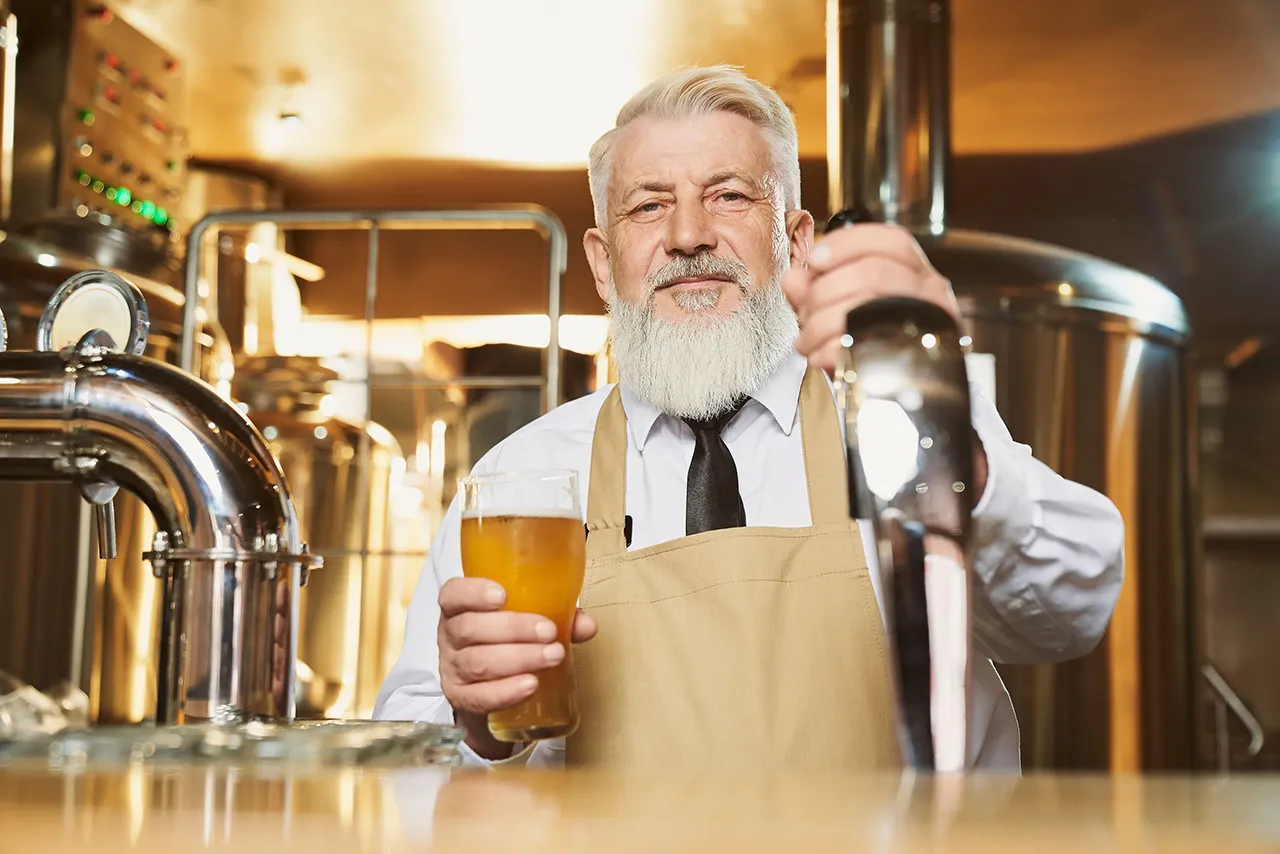 Male bartender with beer glass